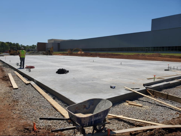 A construction site with a wheelbarrow in the foreground