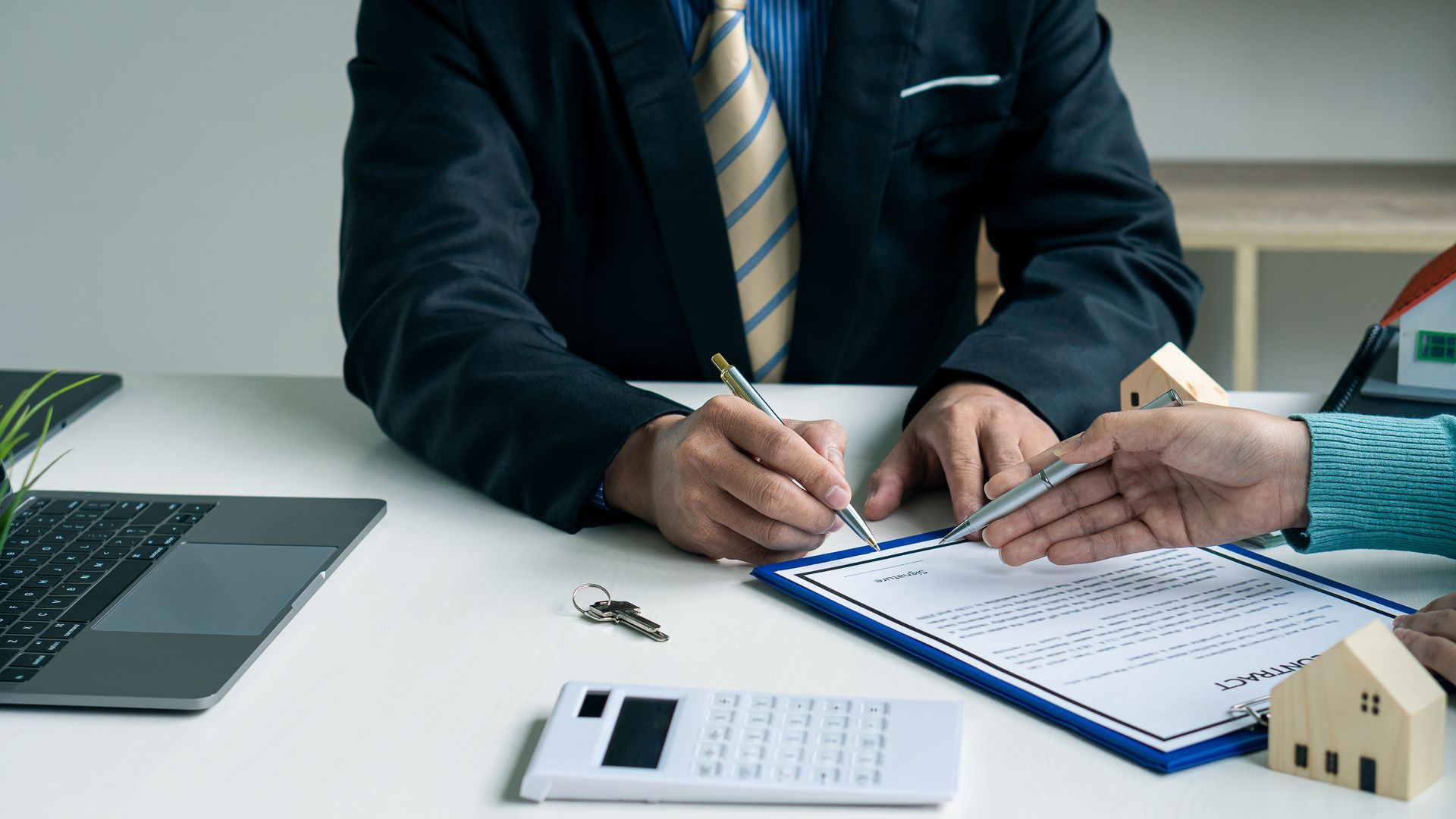 A legal consultation at a desk as the client reviews documents A legal consultation at a desk as the client reviews documents