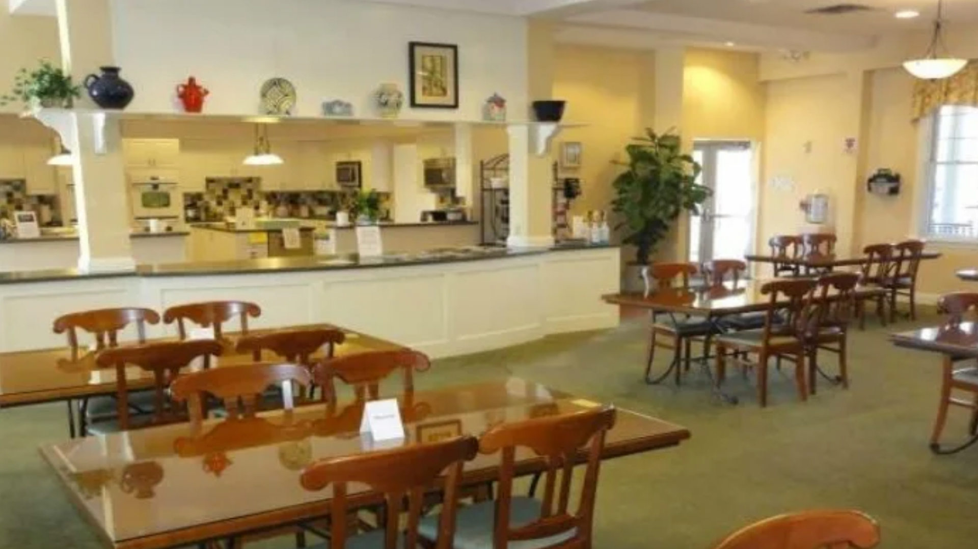 A restaurant with tables and chairs and a counter