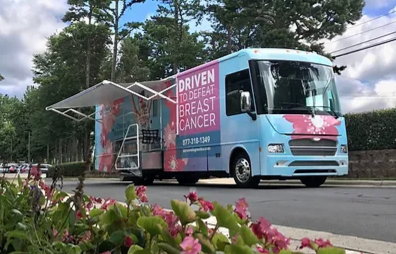 a blue and pink bus that says driven to spread breast cancer