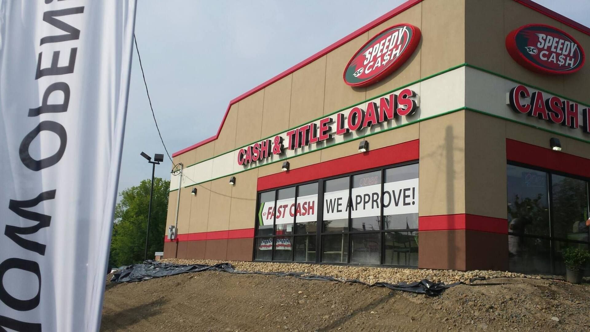 Car Title Loans storefront with a red roof and banner reading “We Approve!”