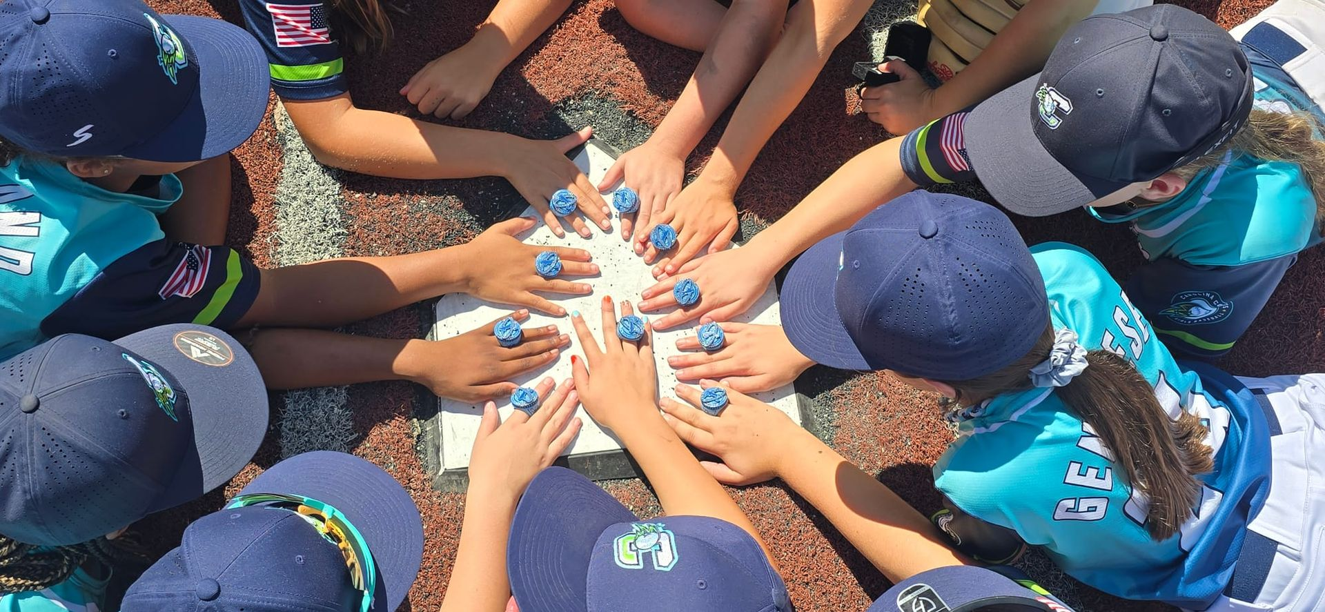 Baseball players with championship rings on home plate