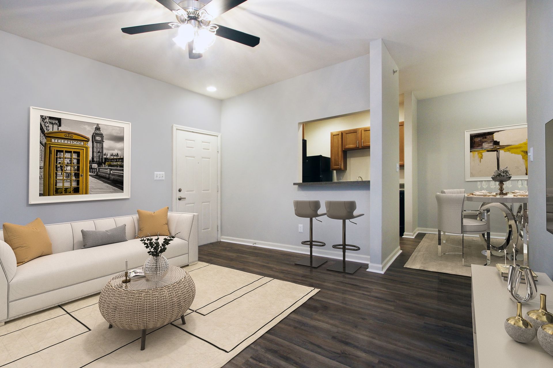 A living room with a couch , coffee table , and ceiling fan.