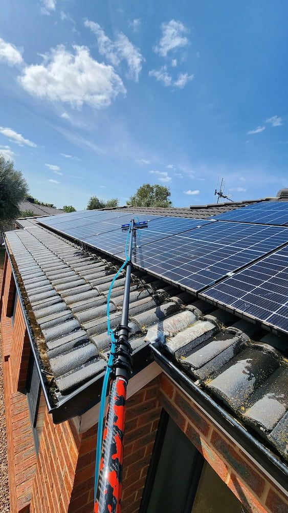 Person Using a Pole to Clean Solar Panels on a Roof — Rapid Rinse Solutions in Shepparton, VIC