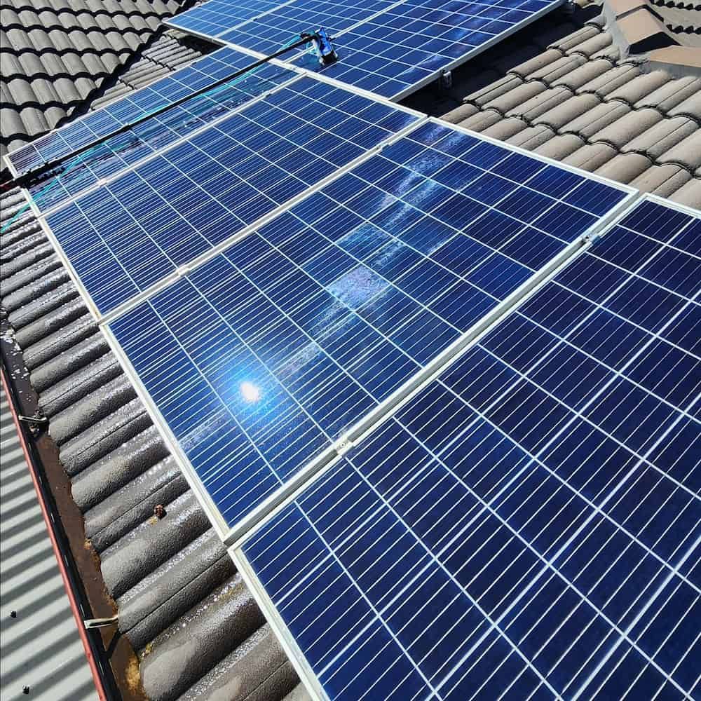 Solar Panels Installed on a Grey Tiled Roof, Capturing Sunlight — Rapid Rinse Solutions in Mooroopna, VIC
