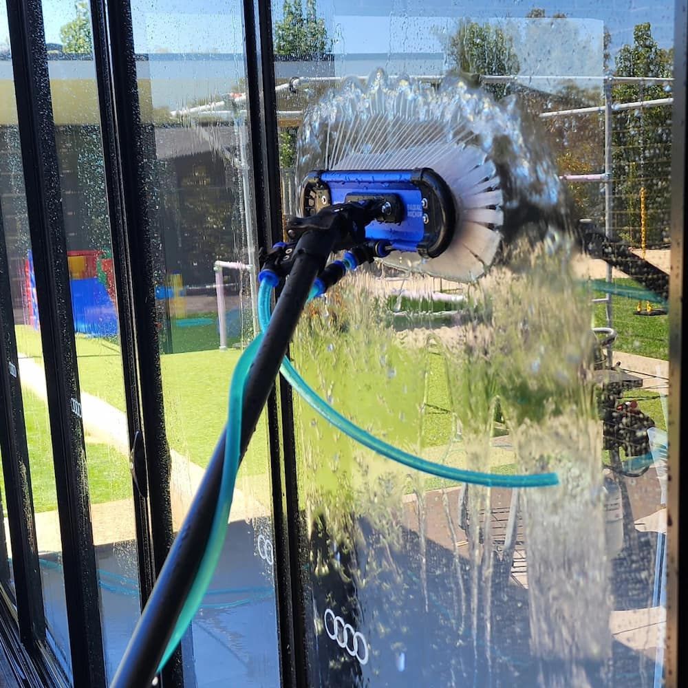 Window Being Cleaned With a Long-handled Brush — Rapid Rinse Solutions in Shepparton, VIC