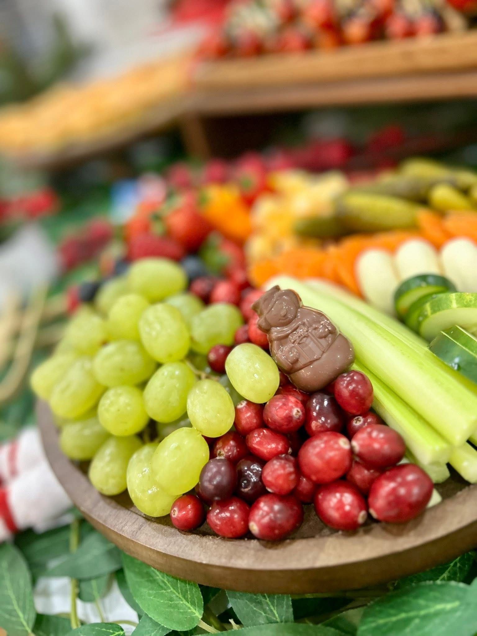 Charcuterie board with various food items arranged for a festive holiday gathering.