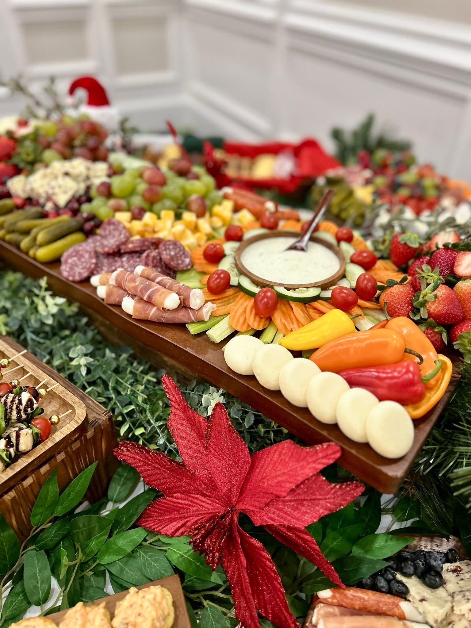 Christmas food spread with snacks, fruits, and Santa hat decorations.