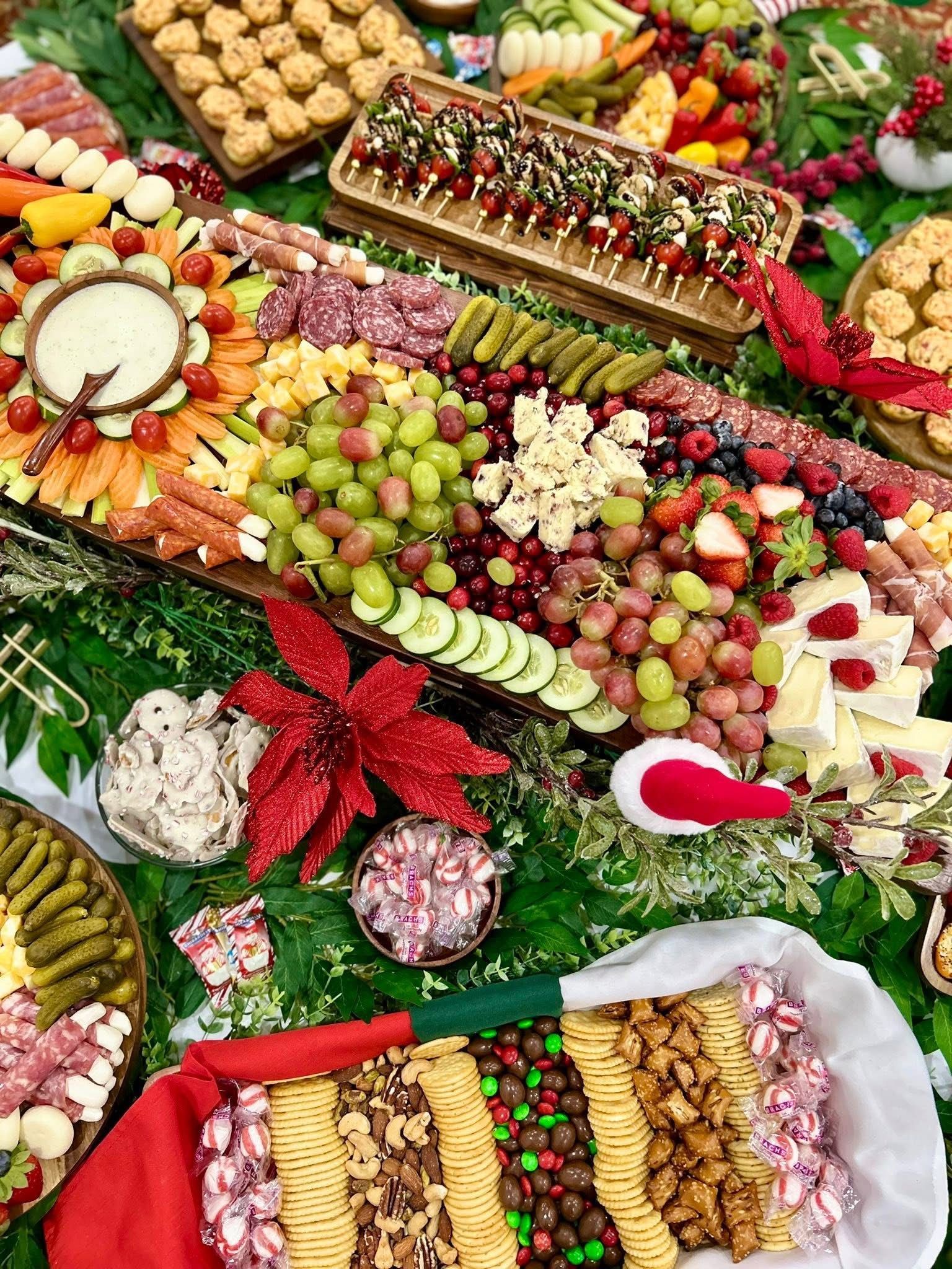 Christmas charcuterie board: colorful array of meats, cheeses, fruits, and crackers arranged on a festive backdrop.