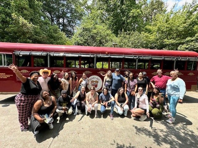 Large group gathered at the red Funny Bus for a comedy city tour