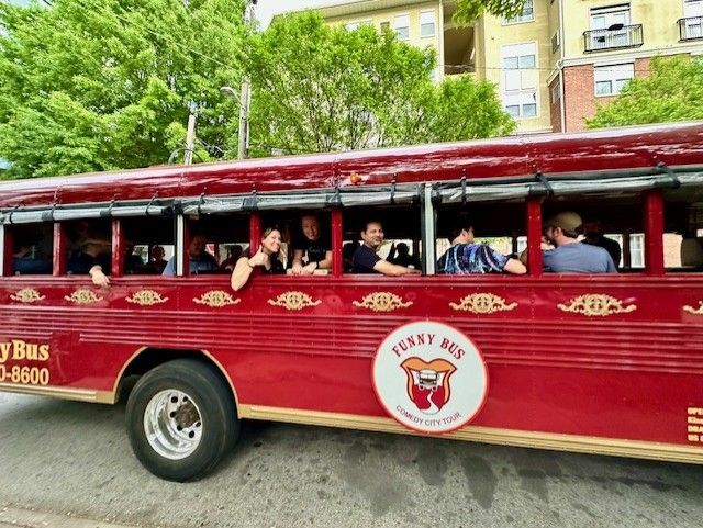 Guests riding the open-air red Funny Bus comedy tour in Atlanta