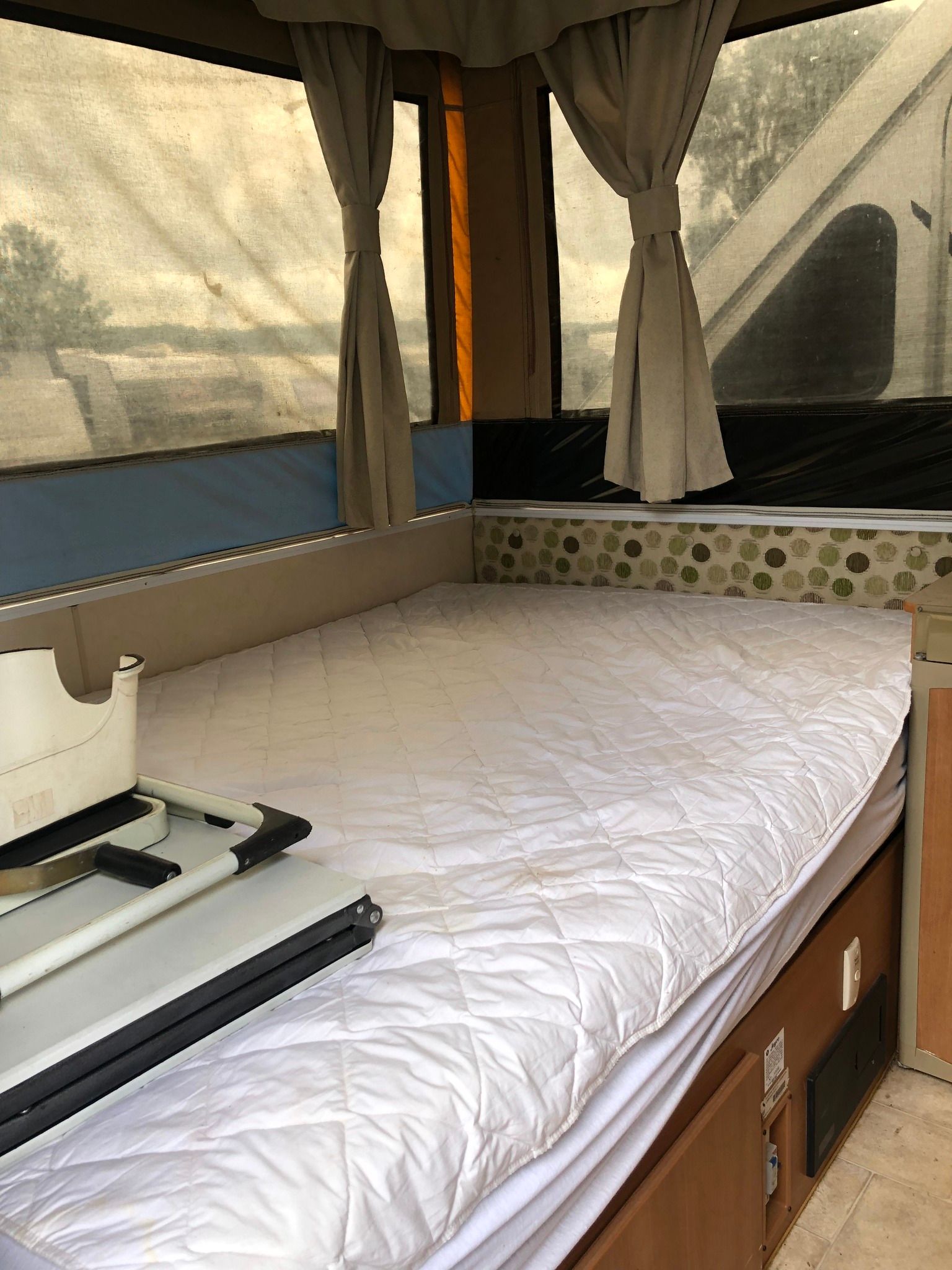 Interior of a Pop-up Camper With a Bed — Great Lakes Caravans & RV P/L In Maitland, NSW