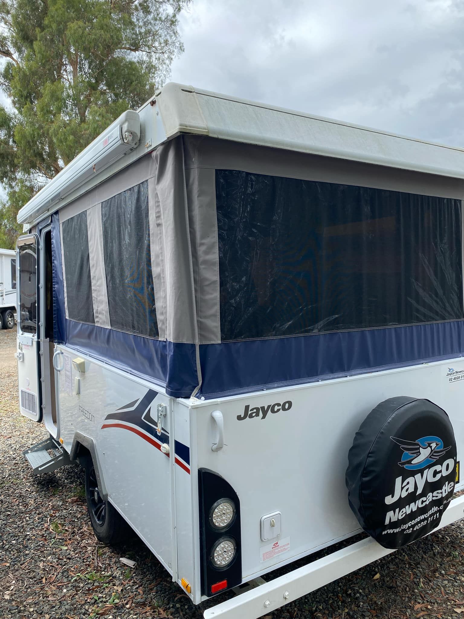 Jayco Pop-up Camper With Spare Tire on the Back — Great Lakes Caravans & RV P/L In Forster, NSW