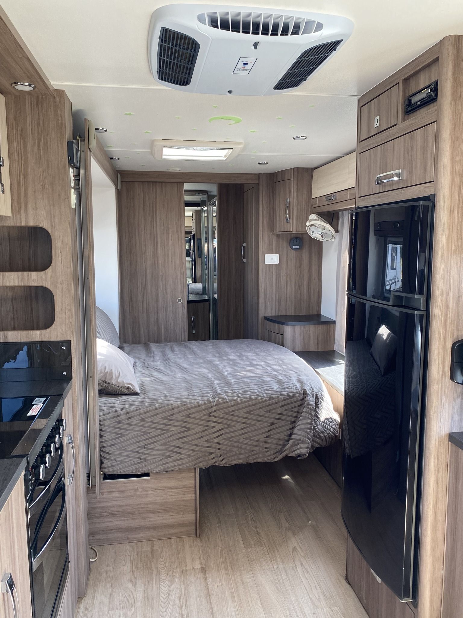 Interior of a Camper, Showing Bed and Refrigerator — Great Lakes Caravans & RV P/L In Nabiac, NSW