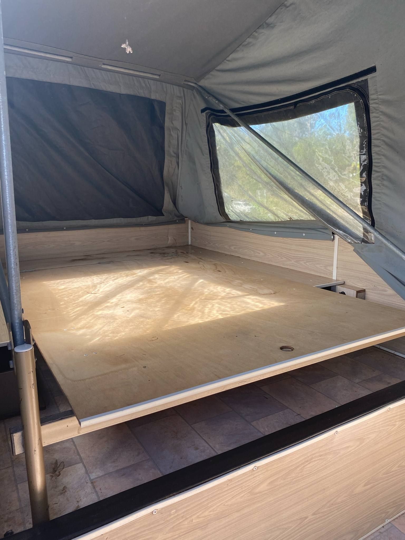Inside of a Camper Trailer With a Wooden Platform — Great Lakes Caravans & RV P/L In Taree, NSW