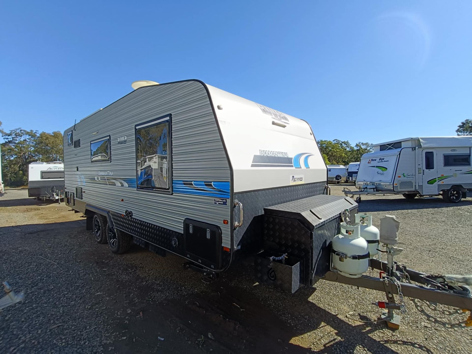 Caravan Trailer Parked Outdoors on Gravel With Blue Sky — Great Lakes Caravans & RV P/L In Maitland, NSW