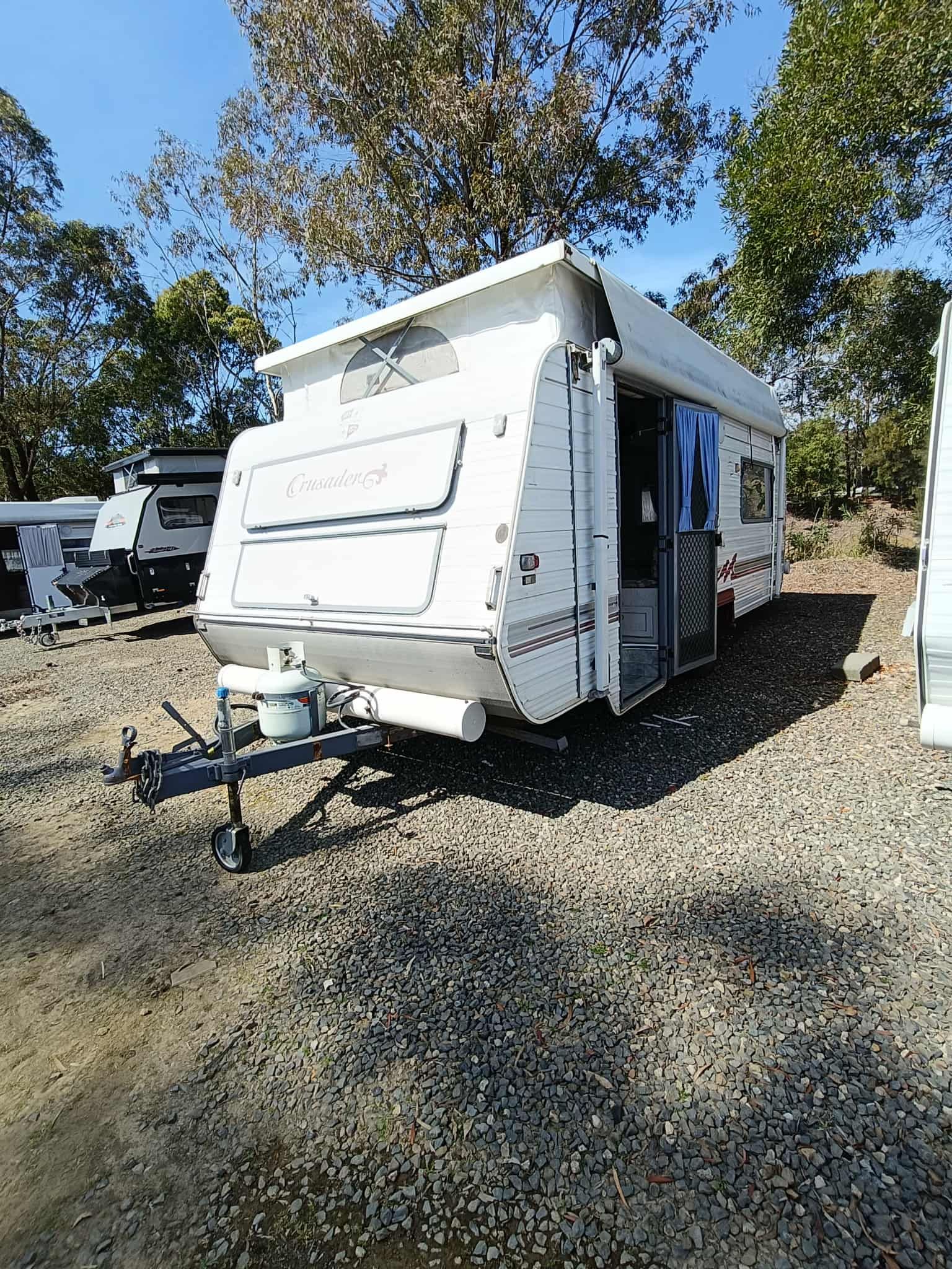 White Pop-up Camper on Gravel, Door Open — Great Lakes Caravans & RV P/L In Newcastle, NSW