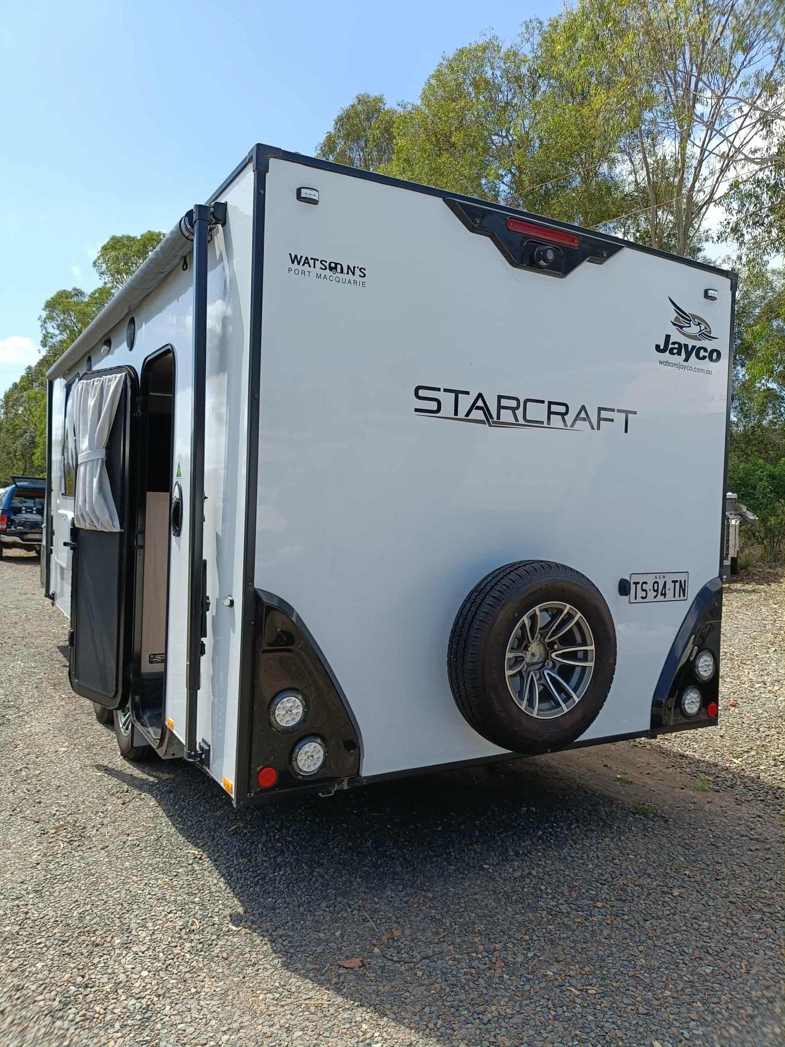 White and Black Starcraft Travel Trailer Parked on Gravel — Great Lakes Caravans & RV P/L In Hunter Valley, NSW