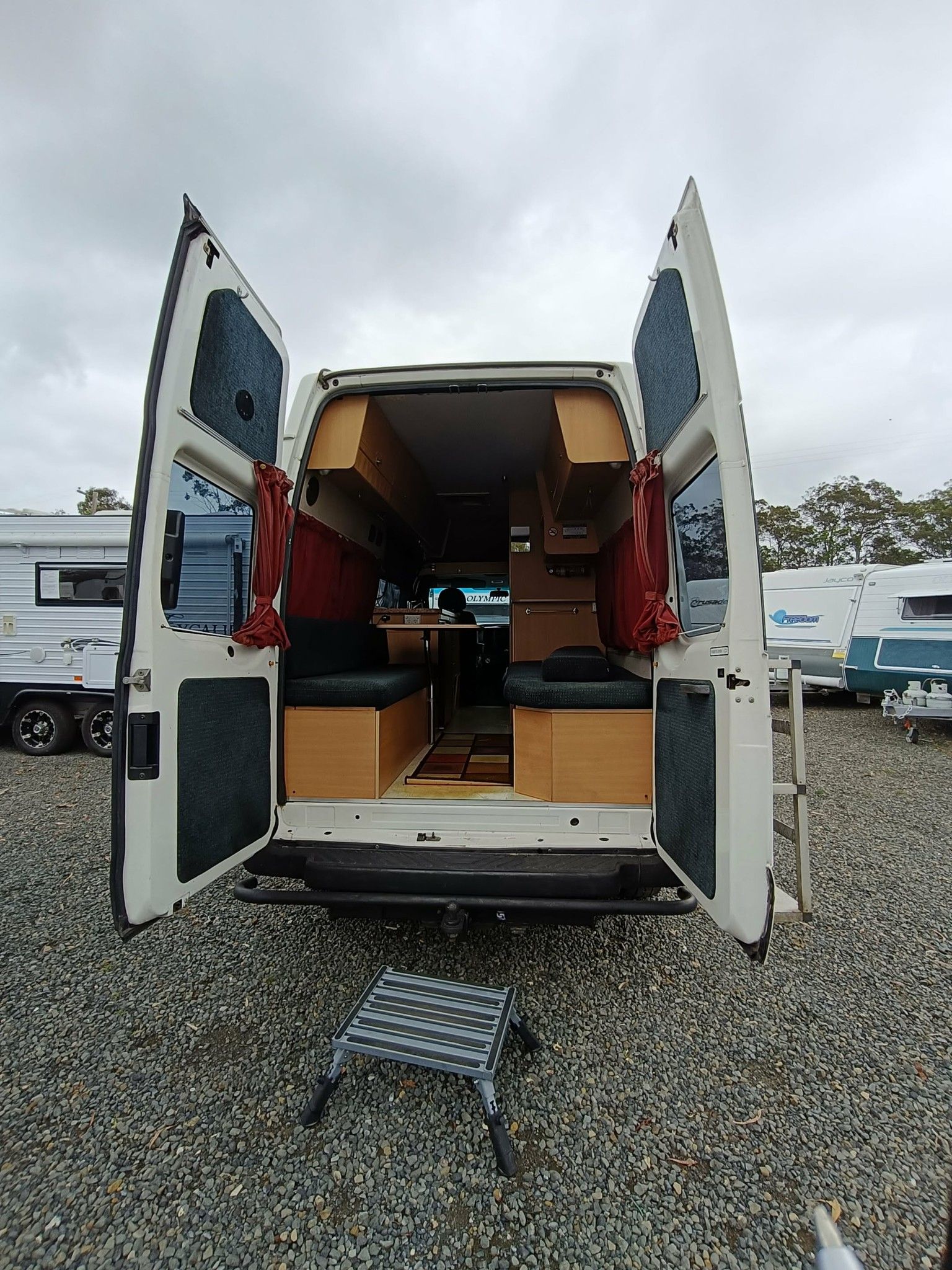 Van With Open Doors Revealing Interior Cabinetry and Seating — Great Lakes Caravans & RV P/L In Hunter Valley, NSW