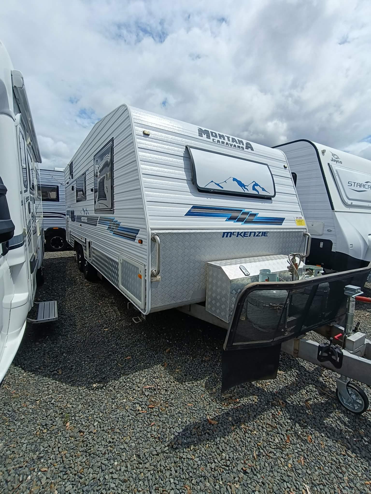 Silver and White Travel Trailer Parked Outdoors on Gravel — Great Lakes Caravans & RV P/L In Nabiac, NSW