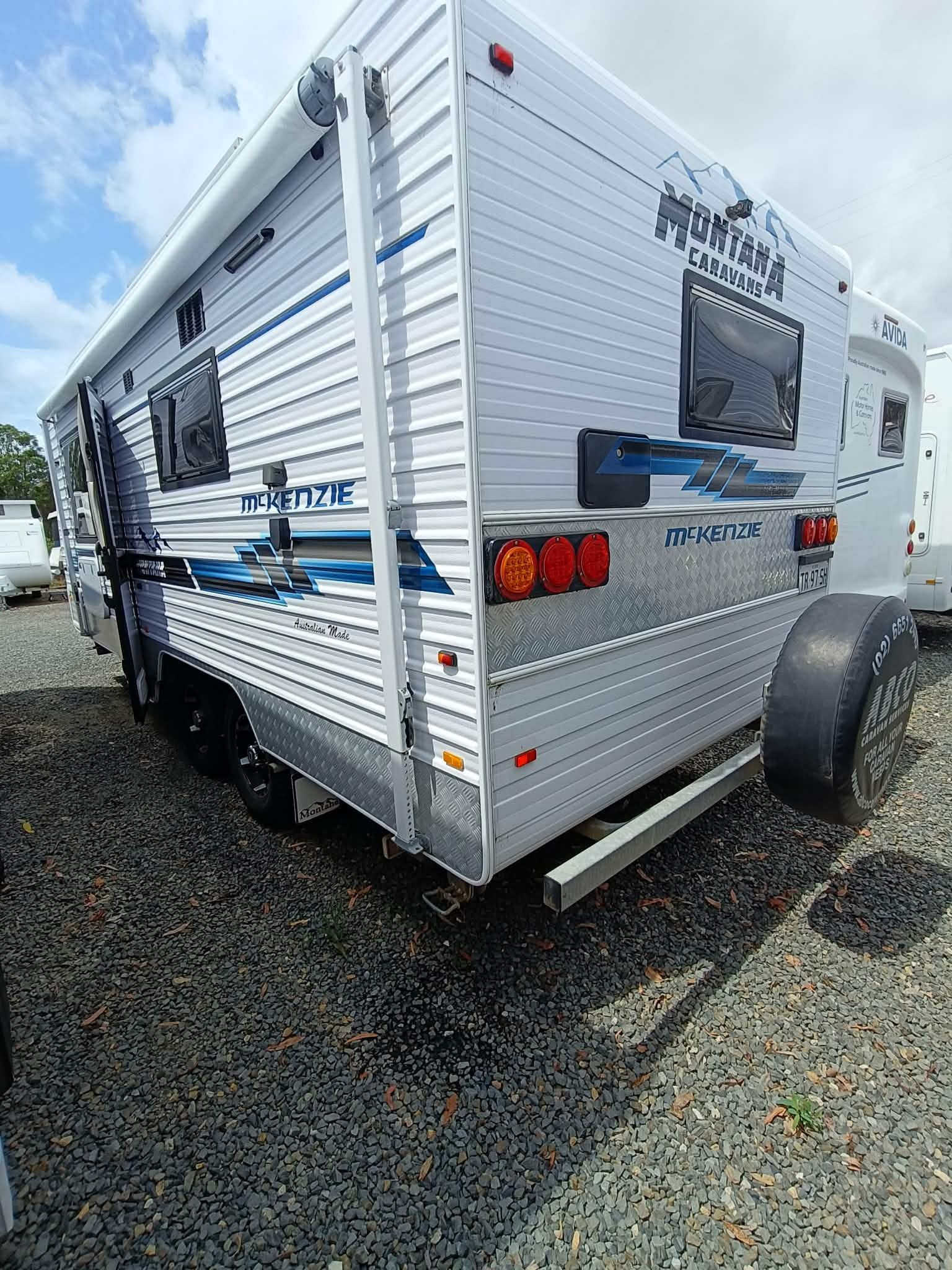 White and Blue Camper Trailer With Spare Tire — Great Lakes Caravans & RV P/L In Nabiac, NSW
