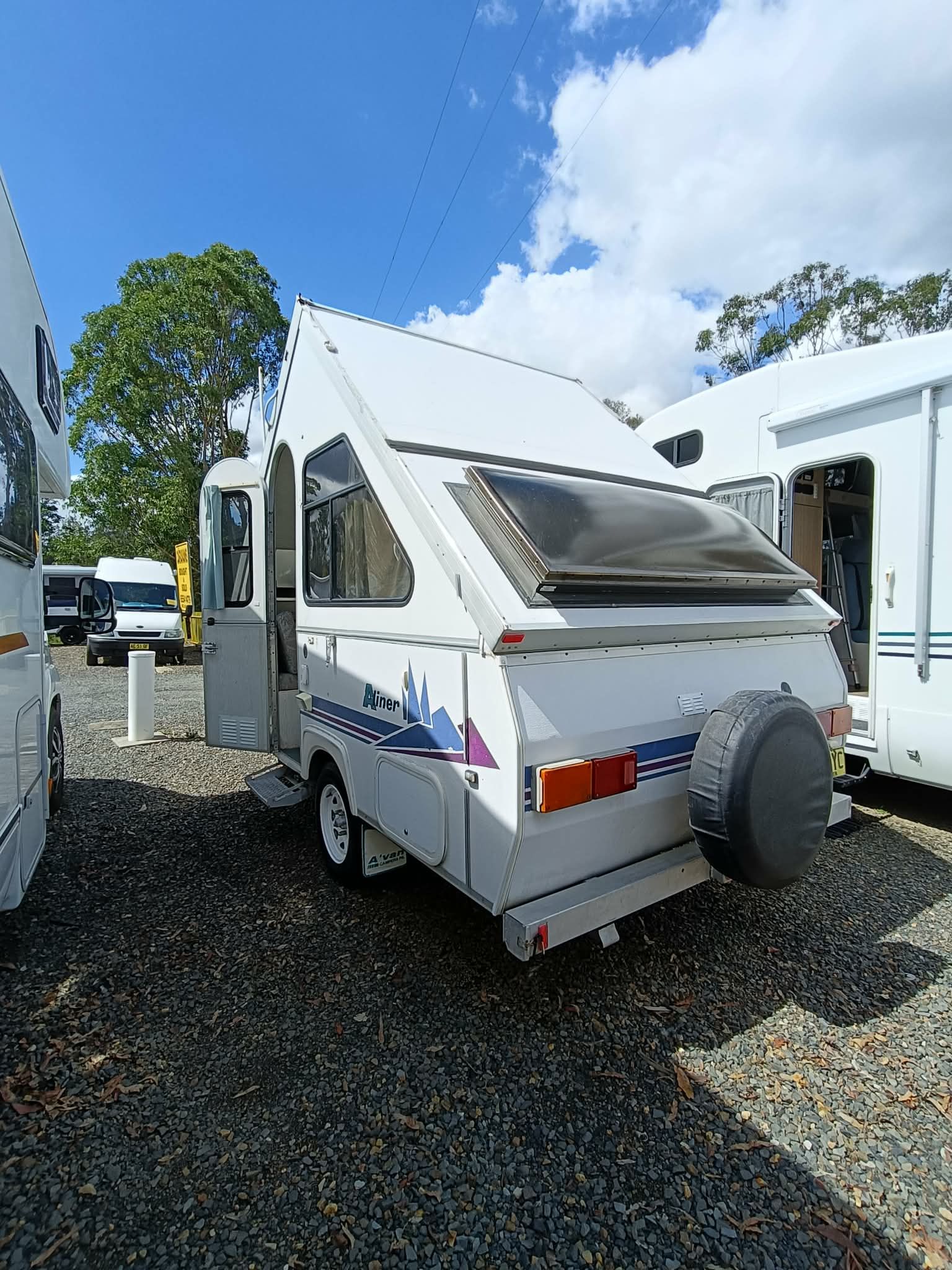 White and Blue Pop-up Camper Trailer Parked Outside — Great Lakes Caravans & RV P/L In Hunter Valley, NSW