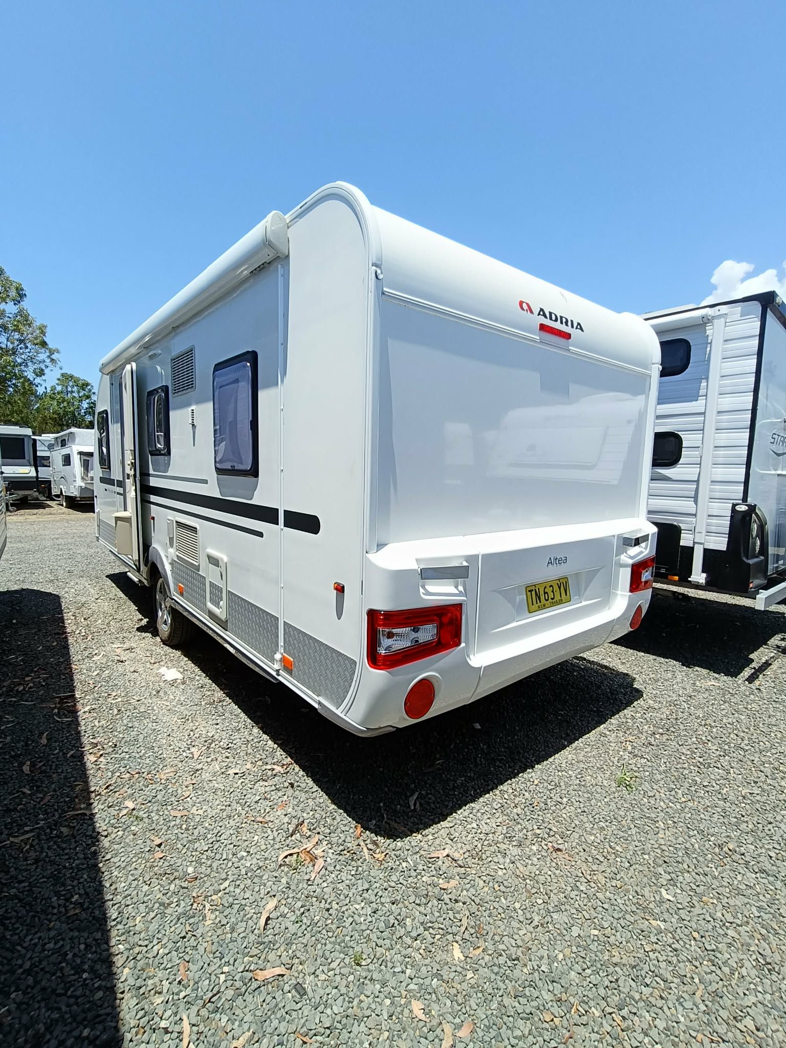 White Camper Trailer in a Gravel Lot — Great Lakes Caravans & RV P/L In Forster, NSW