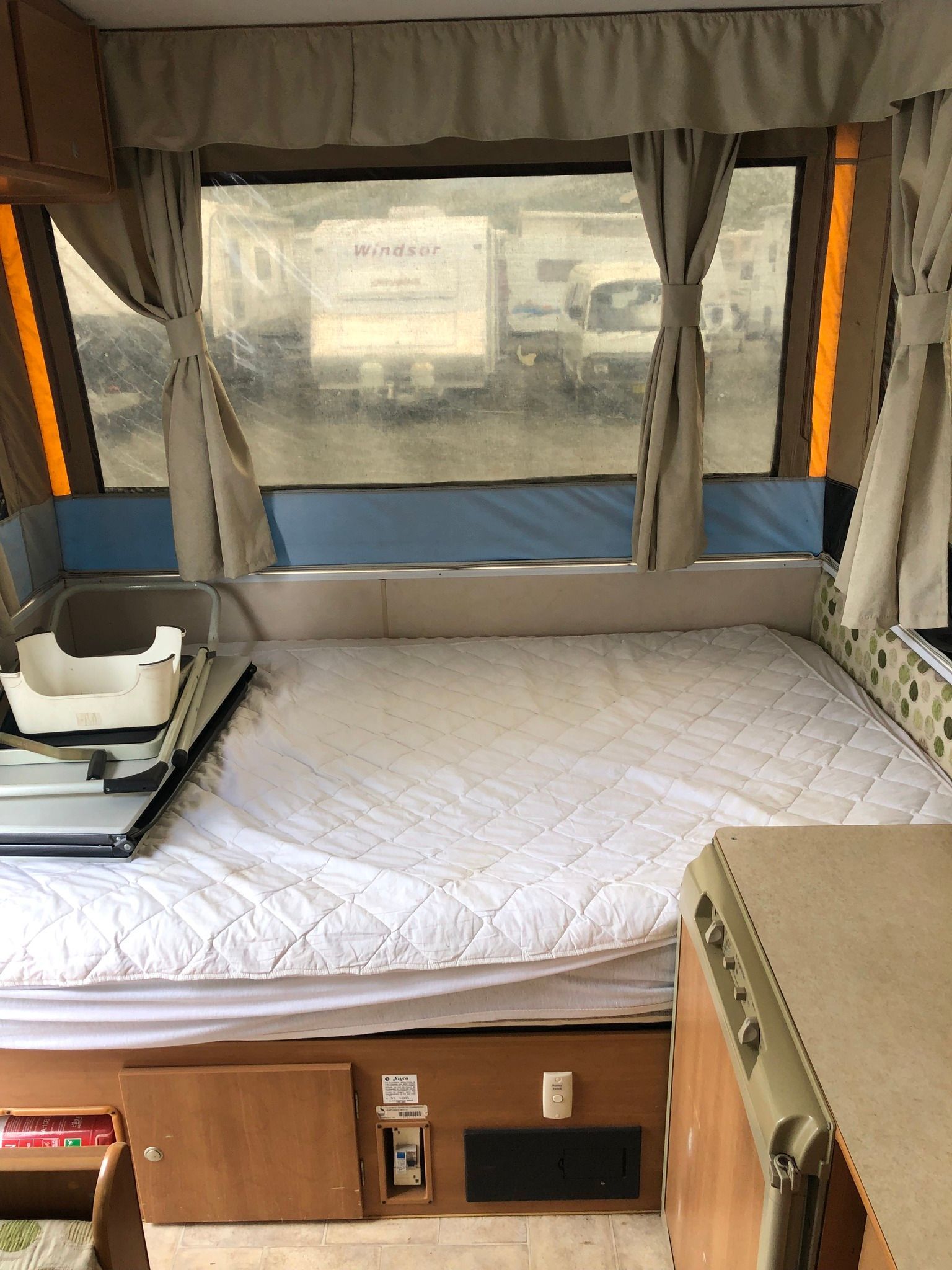 Interior of a Pop-up Camper With a Bed — Great Lakes Caravans & RV P/L In Nabiac, NSW