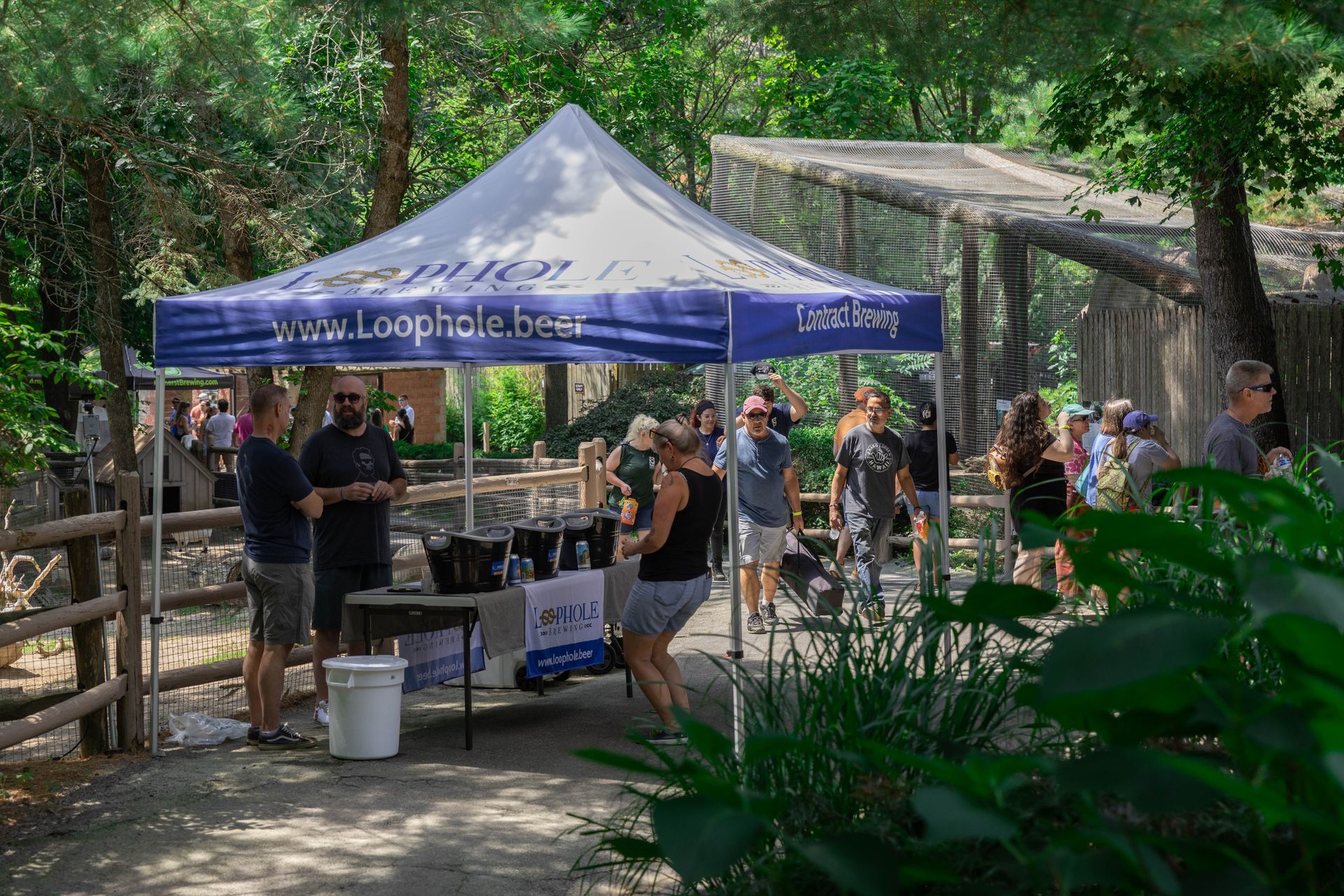 Guests interact with the Loophole Brewing tent at Brew at The Zoo. 