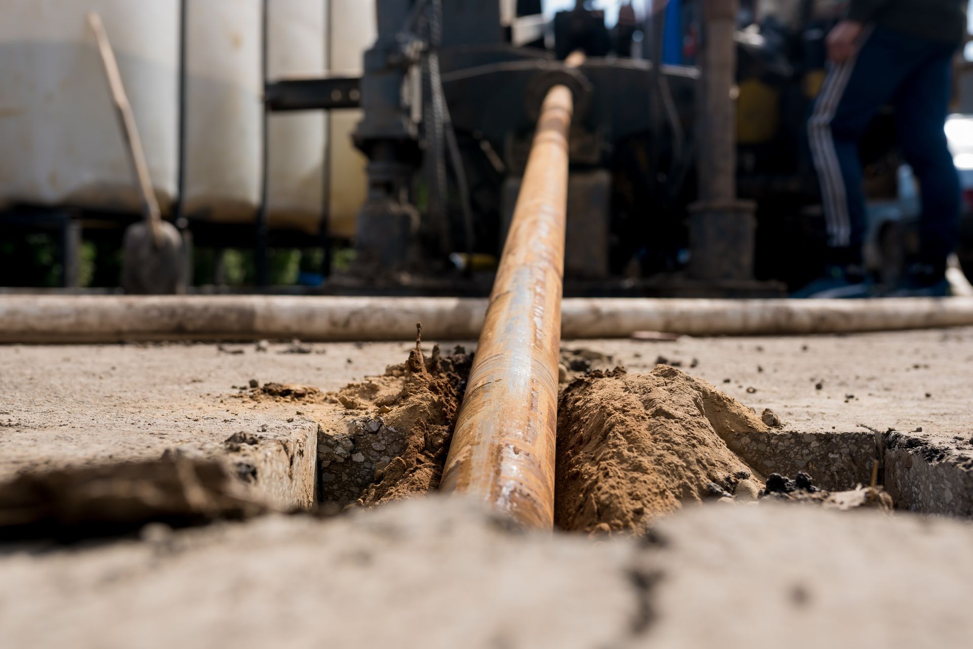 Rusty pipe extending from hole