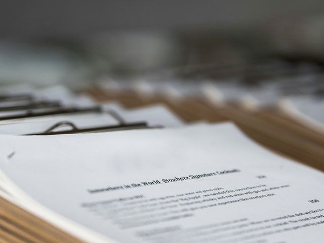 a close up of a clipboard with documents on it
