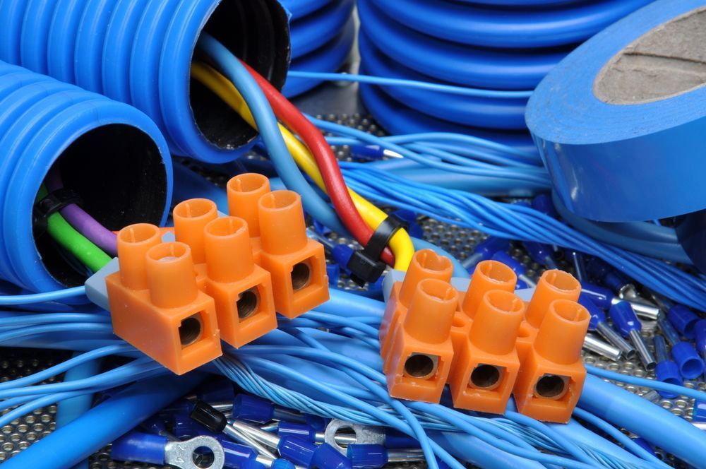 Orange Wire Connectors Among Blue Cables and Bundled Wiring Supplies — Cairns Excel Electrics In Trinity Park, QLD
