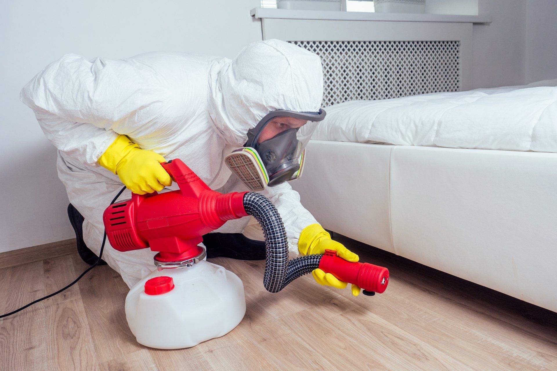 Man Wearing Protective Suite Sprays Disinfectant  | Fort Wayne, IN | Bug Free Pest Control