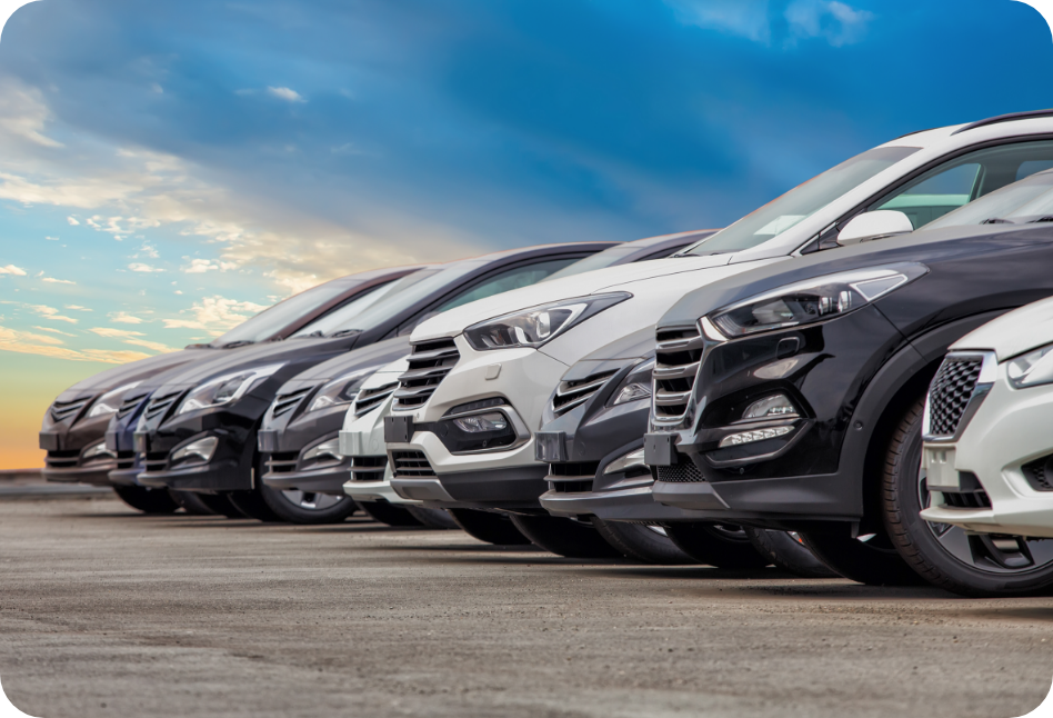 Asset class - Auto - A row of cars are parked in a parking lot.