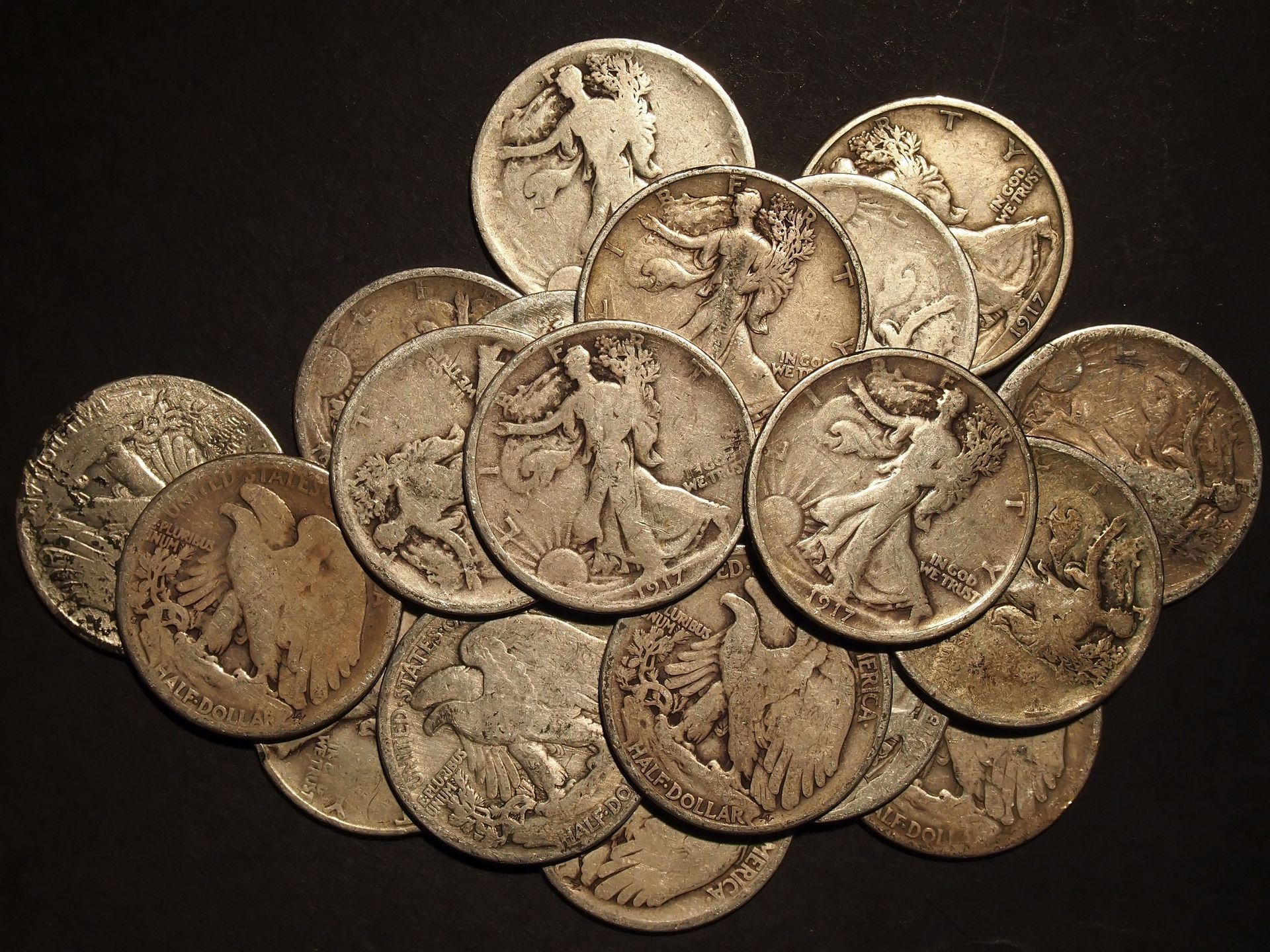 Pile of gold-toned coins overlapping on a dark background