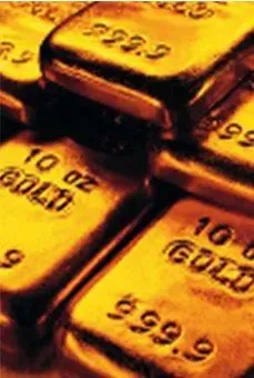 Stacked gold bars with stamped markings, shown in a close-up view.