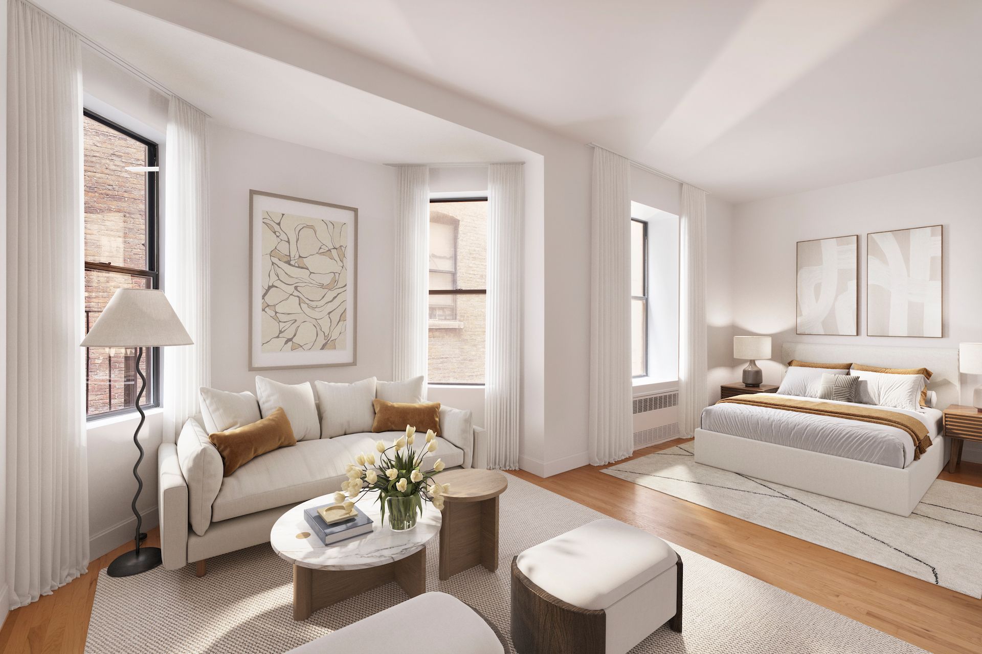 A living room with a couch , coffee table , and bed.