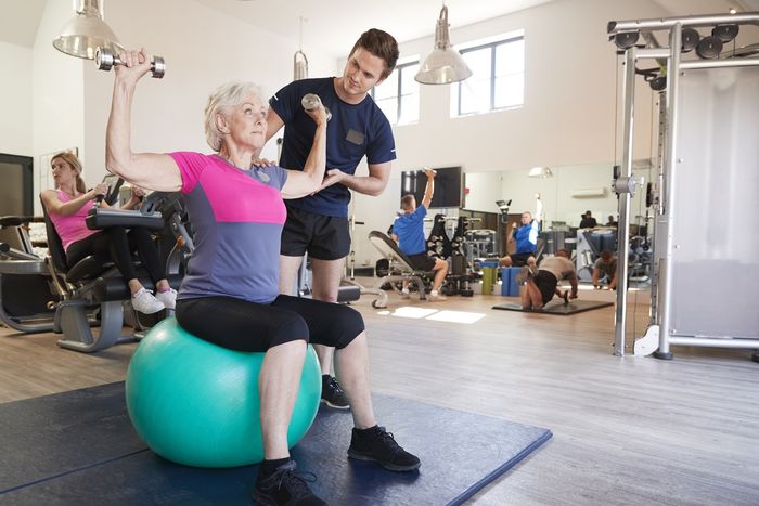 Group of people doing different exercises in the gym.
