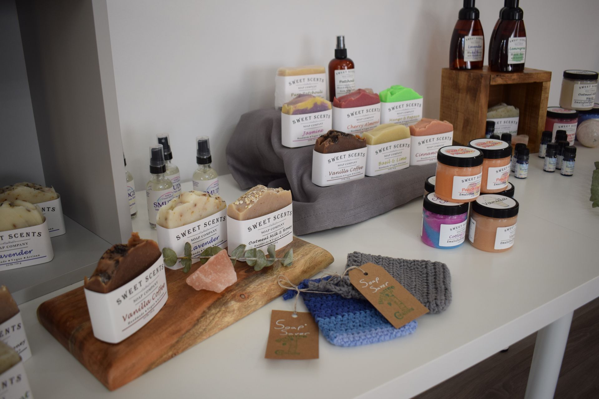 A table with a variety of soaps and bottles on it.