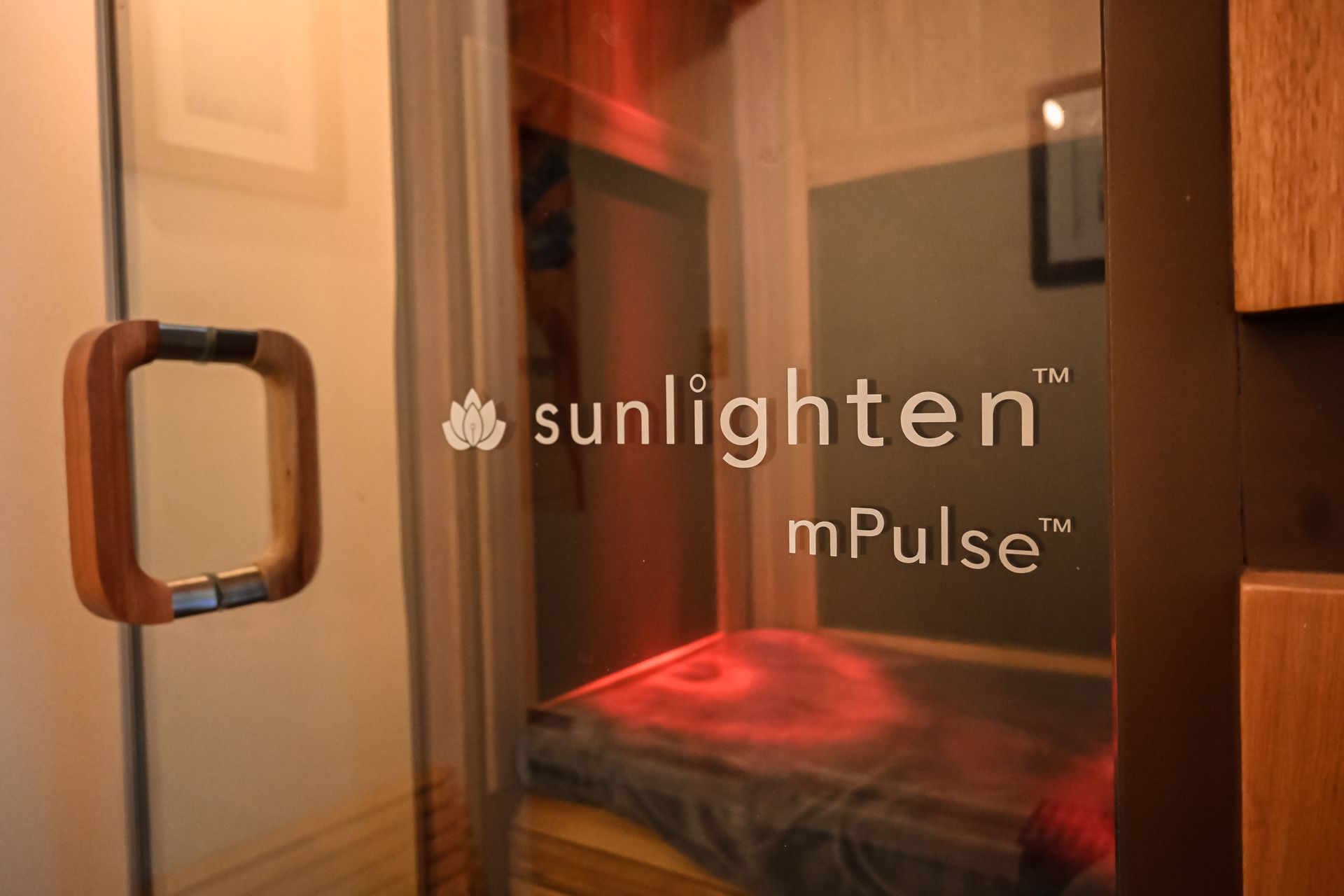 A room with a bed and a door that says sunlighten mpulse on it.