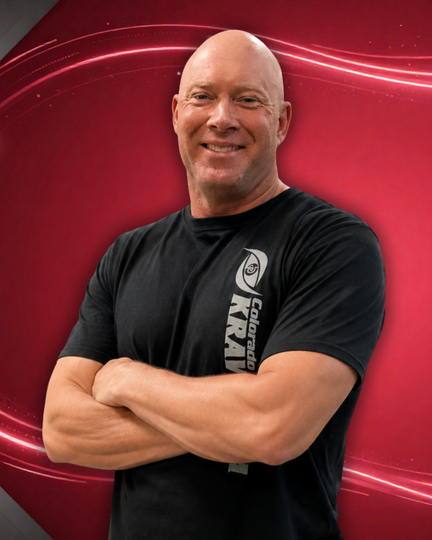 Smiling bald man in a black T-shirt with crossed arms against a red abstract background