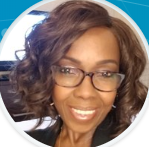 A close up of a woman wearing glasses and smiling.