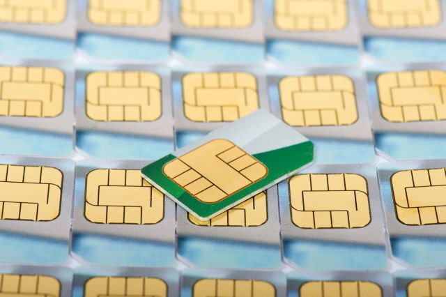 A bunch of sim cards are stacked on top of each other