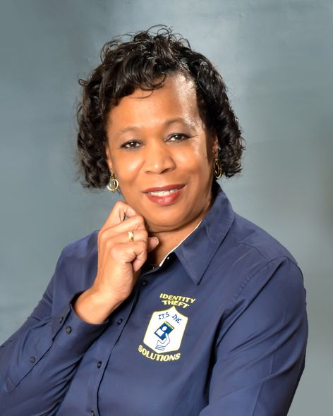 A woman wearing a blue shirt with a crest on it