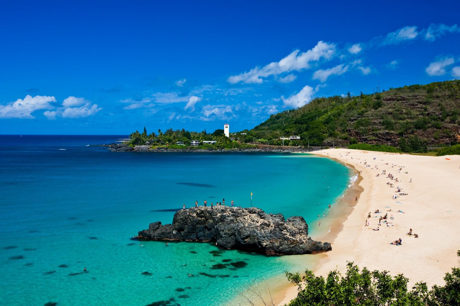 A beach with a lighthouse in the distance