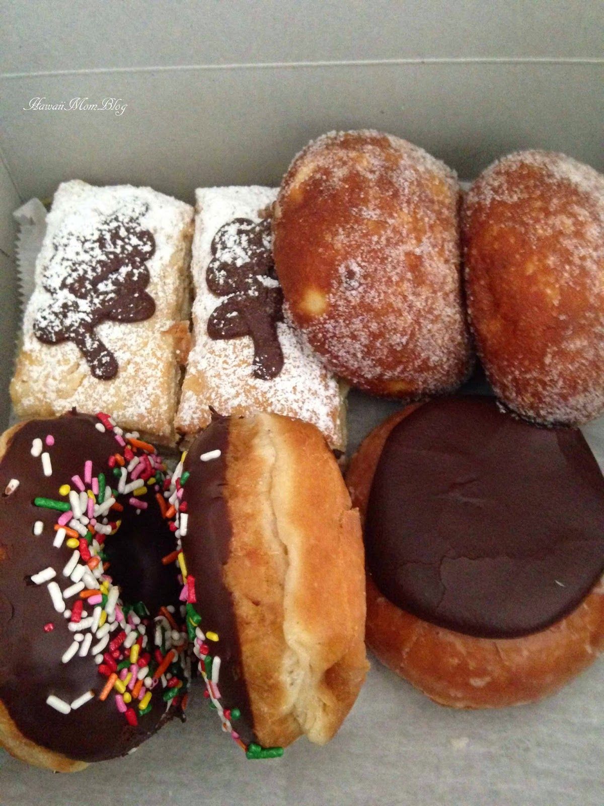 A box filled with a variety of donuts and pastries
