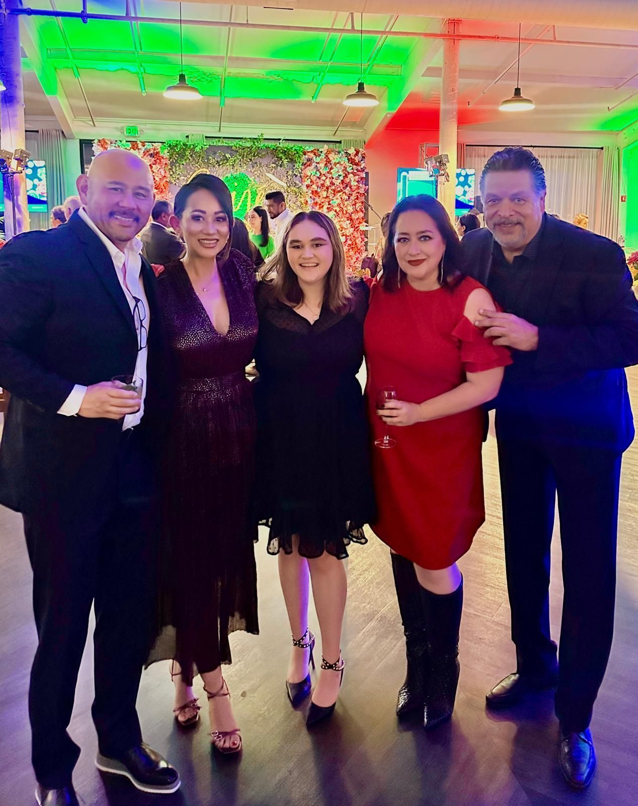 A group of people are posing for a picture at a party.