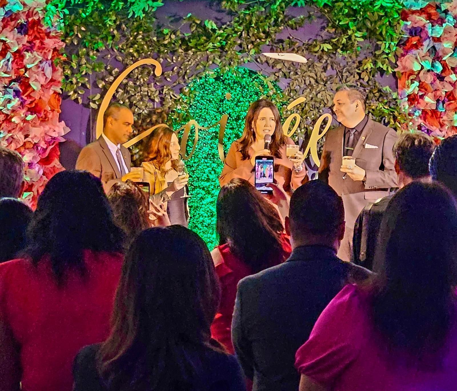 A group of people are sitting in front of a stage.