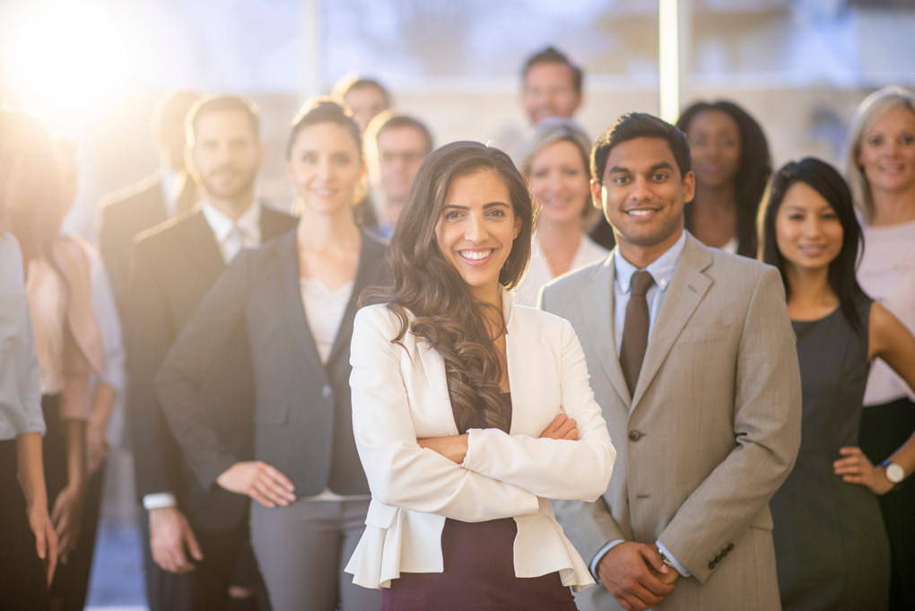 A group of business people are posing for a picture together.