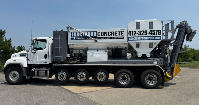 White Cementech truck  with Volumetric Mixers on job site.